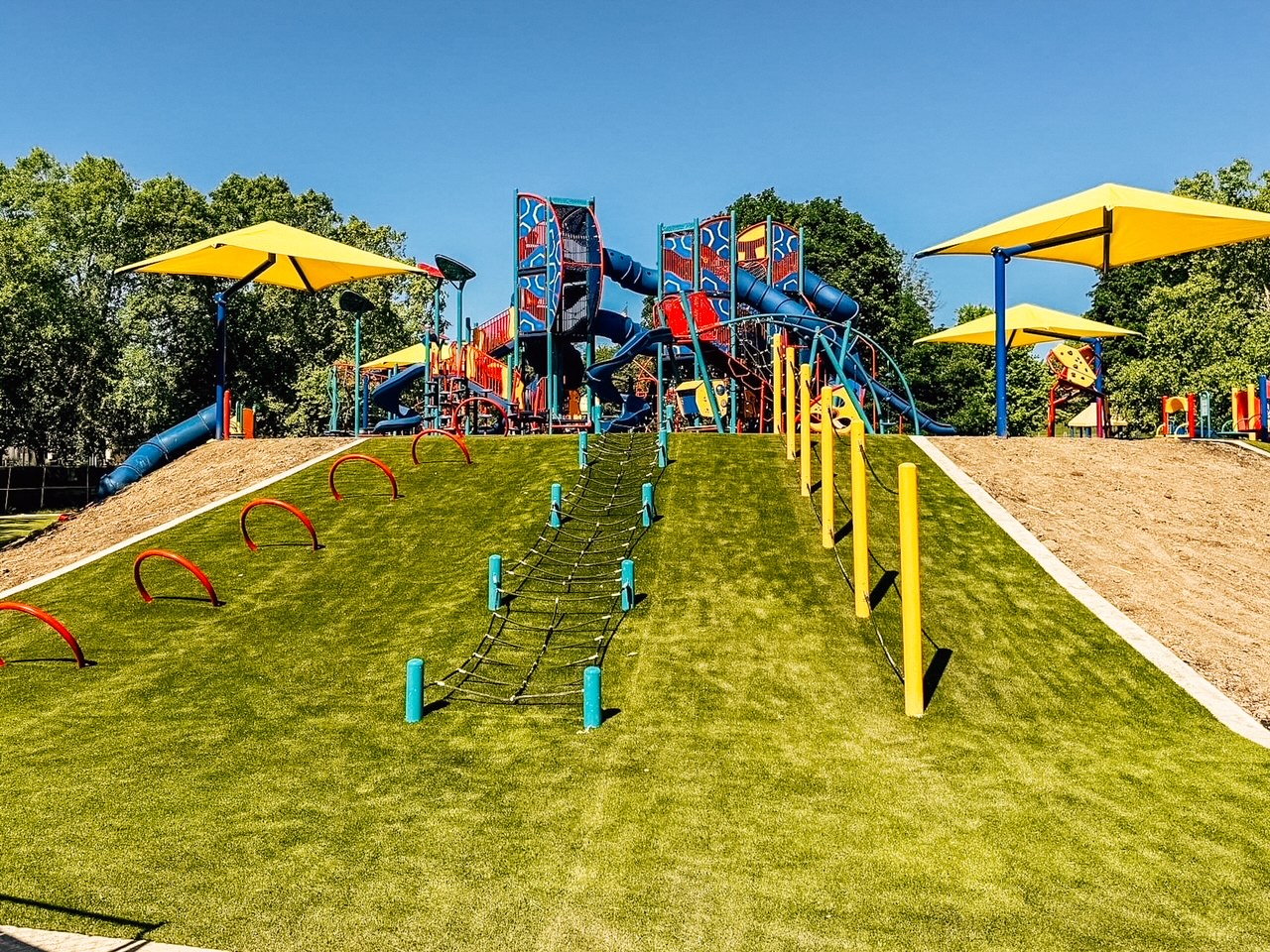 Shade structures and hillside climbers at Columbian Park playground in Lafayette, Indiana