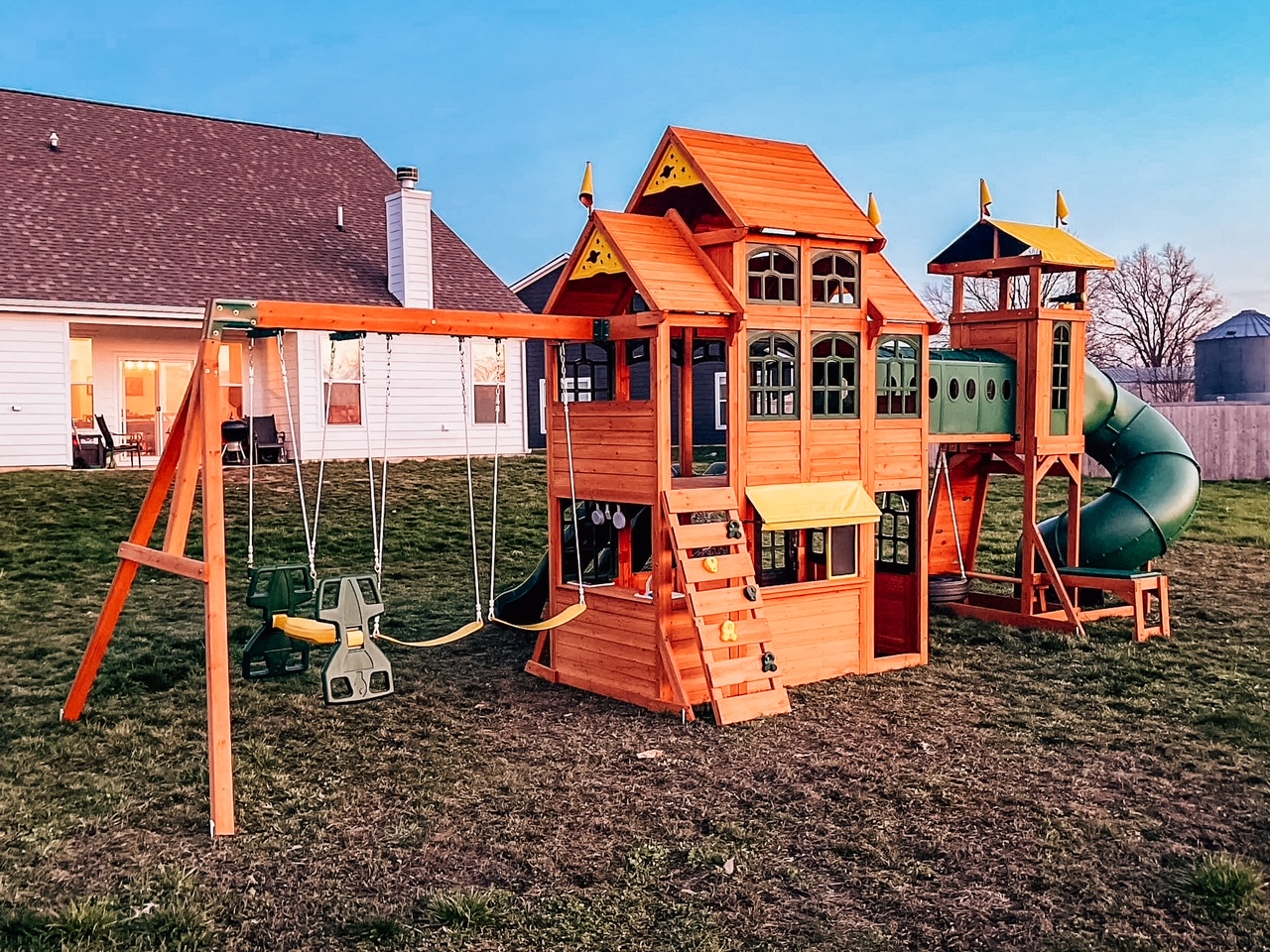 Completed residential playground with swings and slide in Indiana backyard