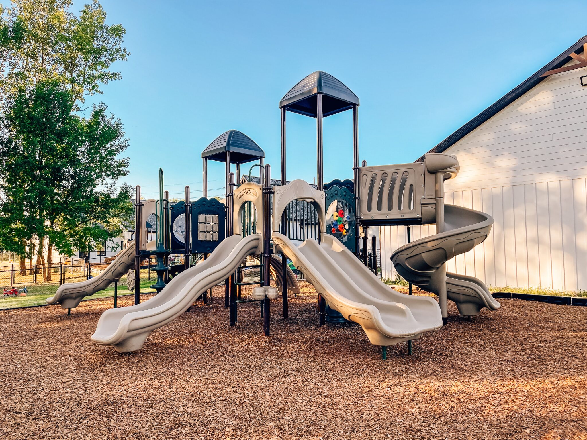 Wide view of the new playground at Kaleidoscope Kids Daycare showing all play structures.