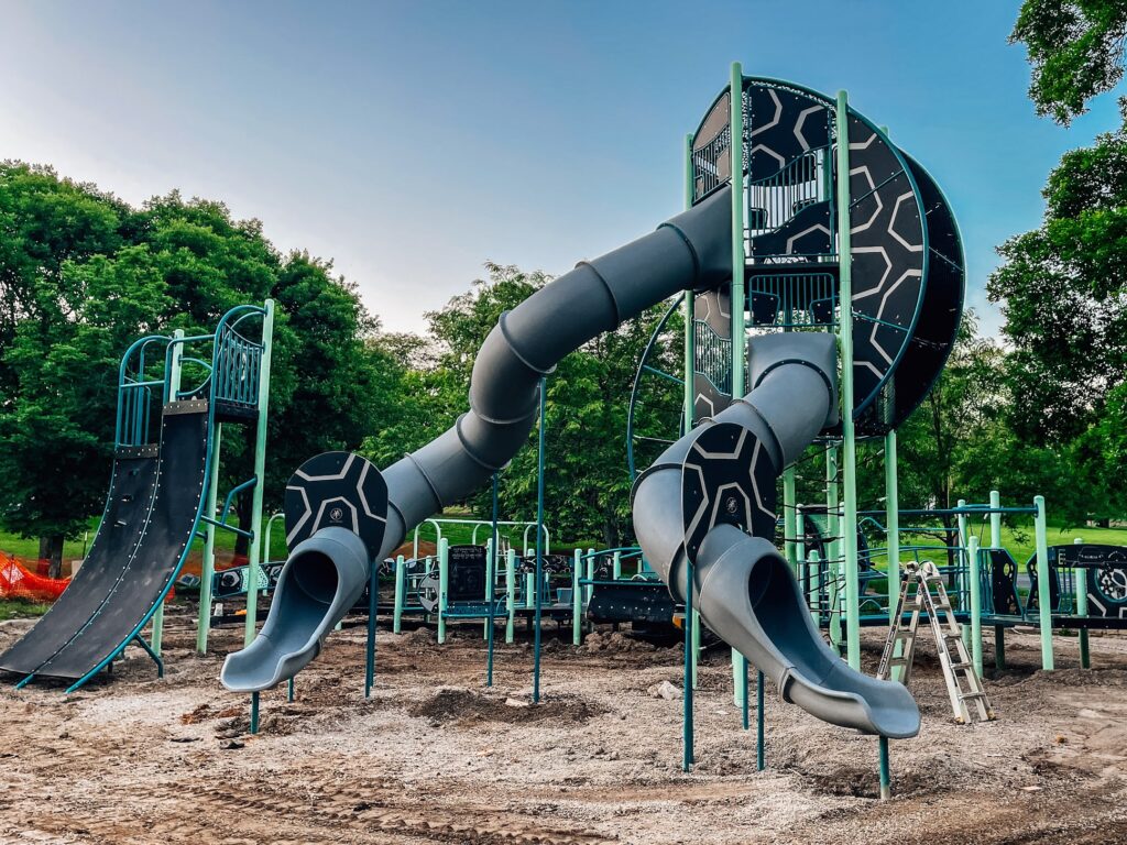 Tall tower with slides as part of commercial playground equipment in Bloomington, IN