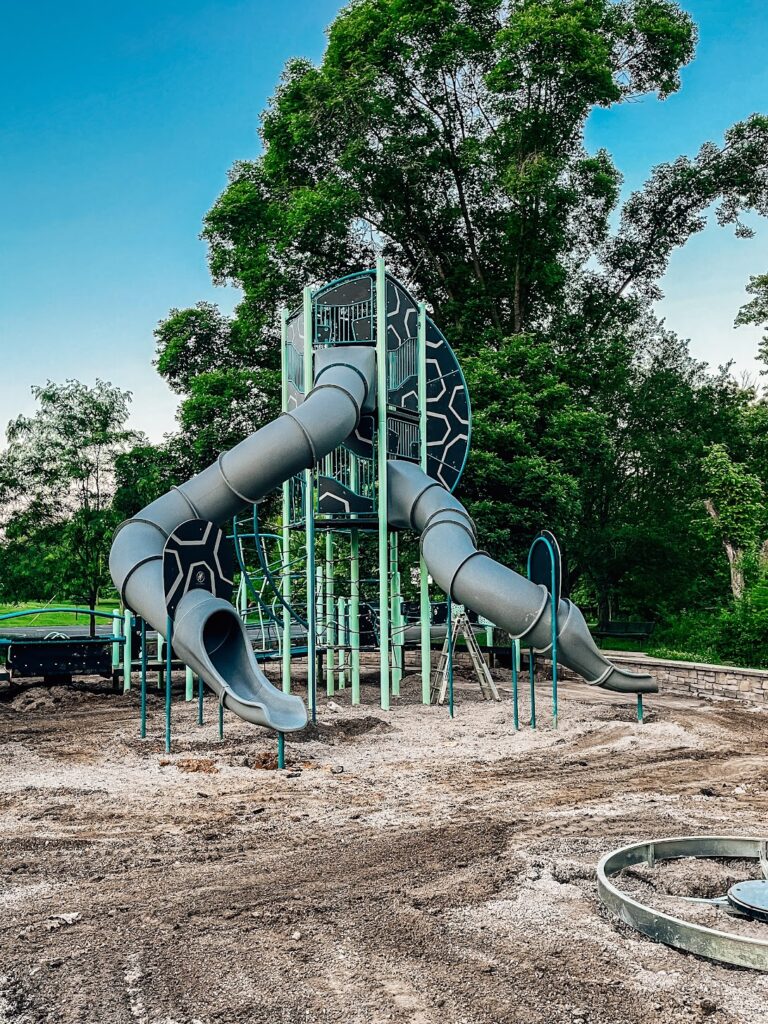 Tall tower with slides as part of commercial playground equipment in Bloomington, IN