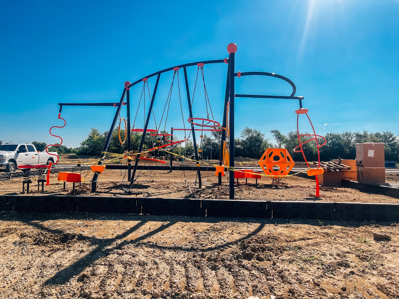 Children climbing on rope elements of a commercial playground structure in Danville.