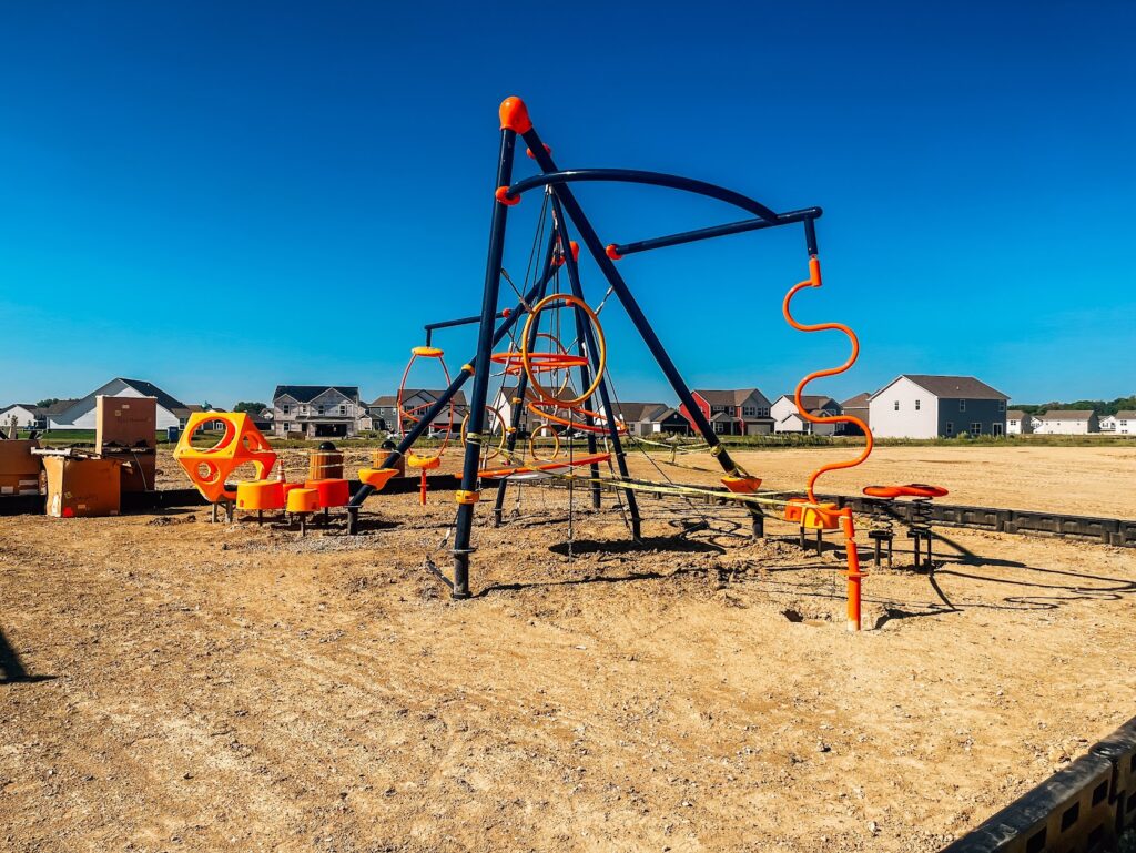 Side view of playground steppers and climbing features at a neighborhood park in Danville.