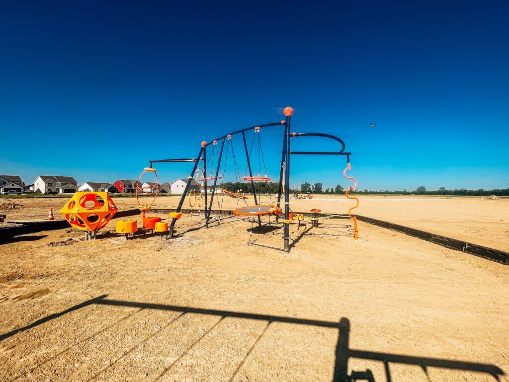 Climbing playground structure with rope features, platforms, and steppers installed in a Danville, Indiana neighborhood by JMSC Build & Play.