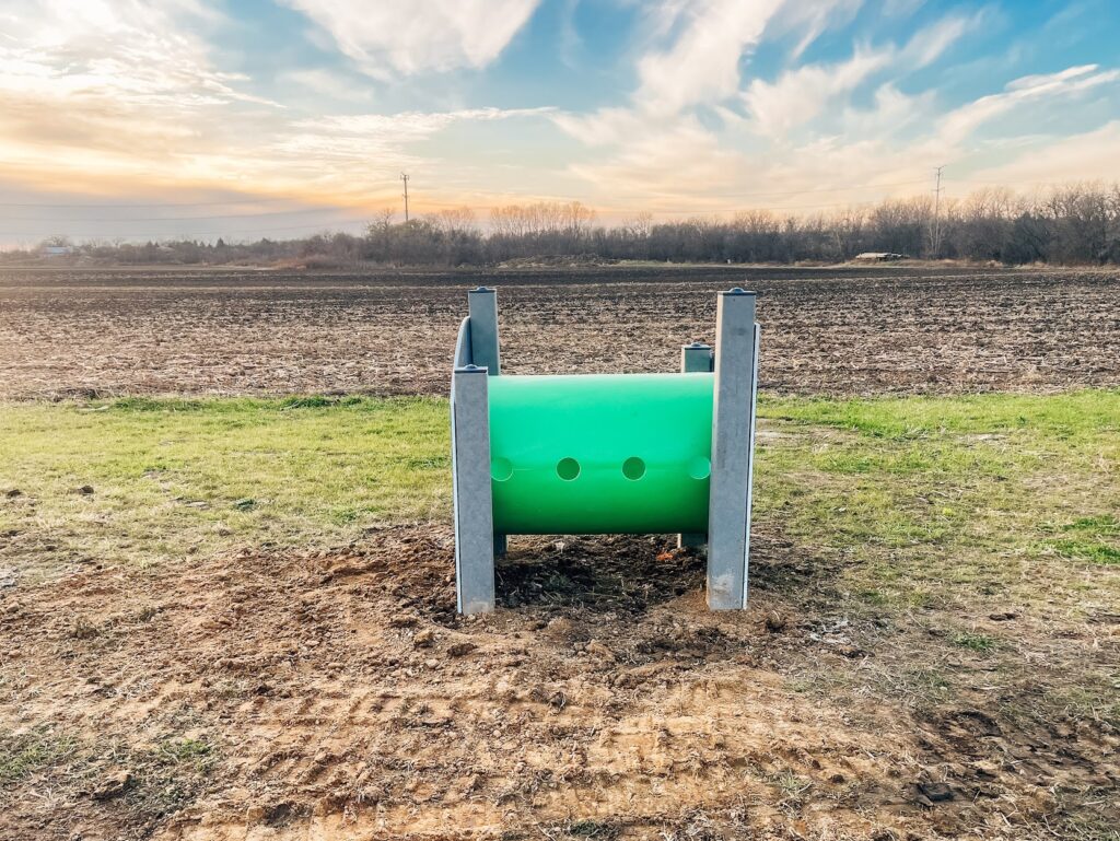 Empty crawl tunnel in a commercial dog park in Kenosha, part of the agility training features.