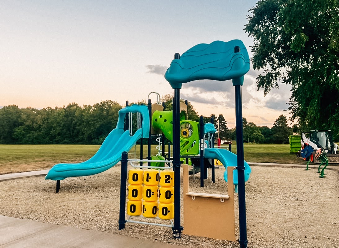 Small playground play structure with slides and tunnel in Lewistown, Illinois.
