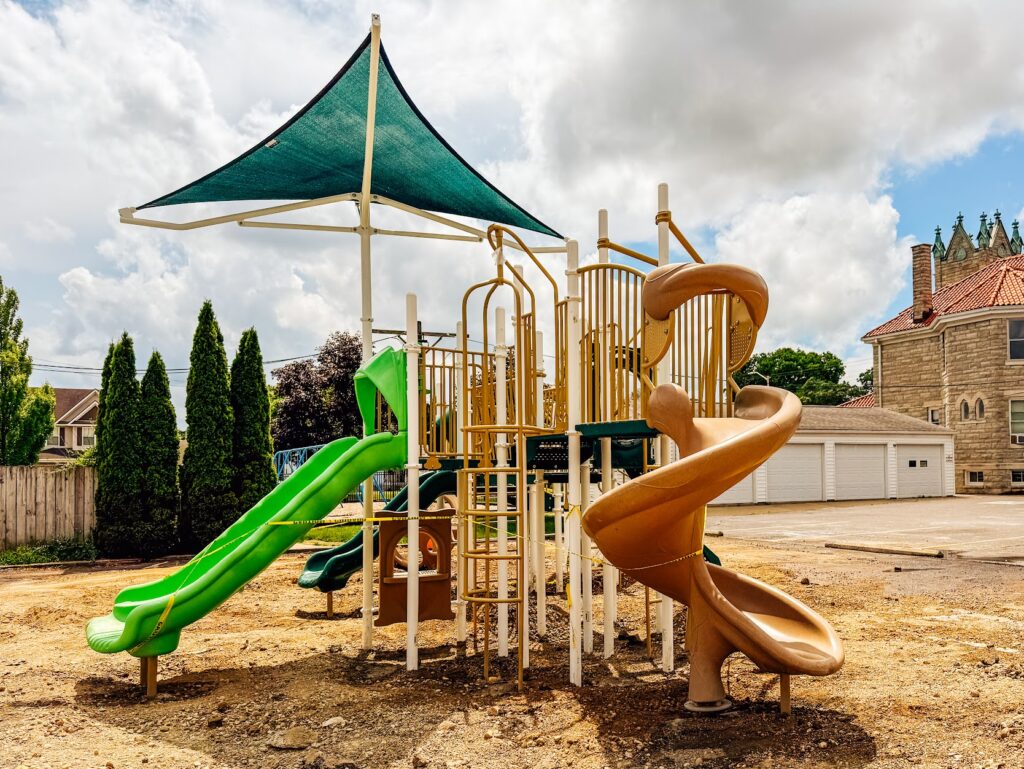 Overhead shade canopy covering part of a playground structure in Troy, Ohio.