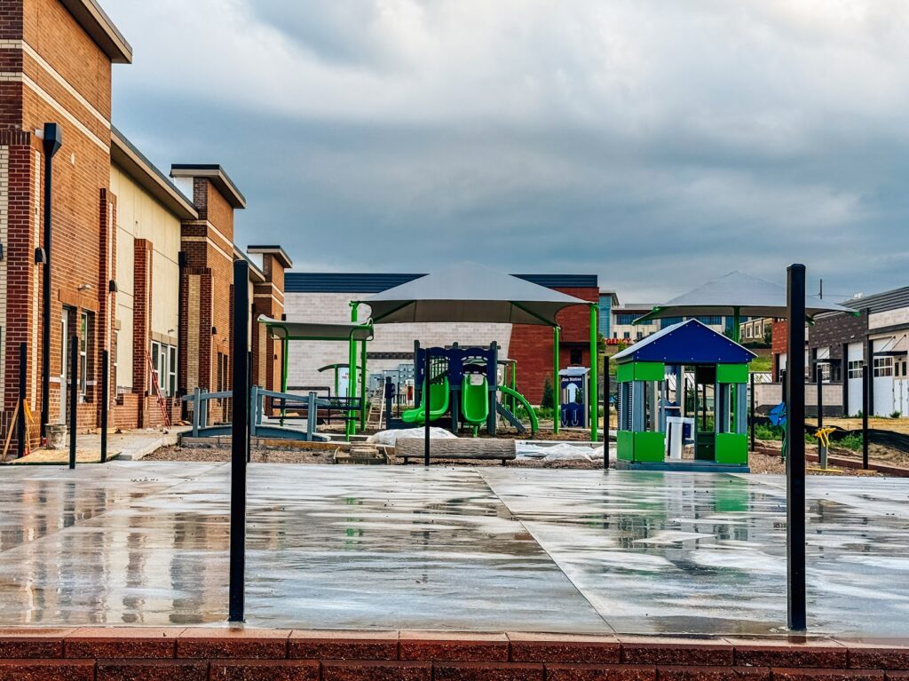 Second climbing play structure installed at Kiddie Academy in Castle Rock, featuring rock climber and slides.