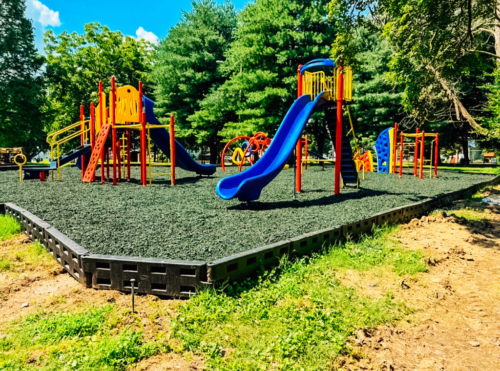 Full view of the new playground in Cairo, Illinois featuring climbing structures, slides, and monkey bars.